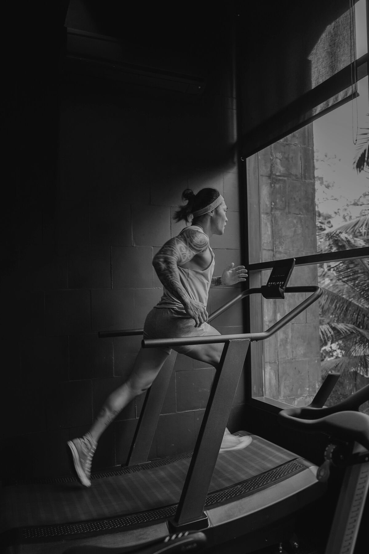 Member running on the cardio deck with jungle views